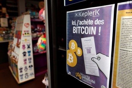 A placard of French startup Keplerk, for clients to purhcase bitcoins, is seen inside a tobacco shop Bitcoin